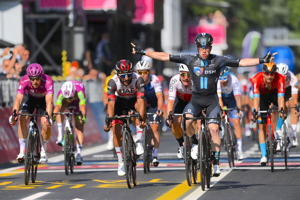 REGGIO EMILIA, ITALY - MAY 18: Alberto Dainese of Italy and Team DSM celebrates at finish line as stage winner ahead of (L-R) Arnaud Demare of France and Team Groupama - FDJ Purple Points Jersey, Fernando Gaviria Rendon of Colombia and UAE Team Emirates and Simone Consonni of Italy and Team Cofidis during the 105th Giro d'Italia 2022, Stage 11 a 203km stage from Santarcangelo di Romagna to Reggio Emilia/ #Giro / #WorldTour / on May 18, 2022 in Reggio Emilia, Italy. (Photo by Tim de Waele/Getty Images)
