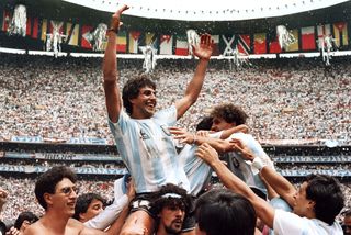 Argentina midfielder Ricardo Giusti is lifted up by fans after the World Cup final victory against West Germany in 1986.