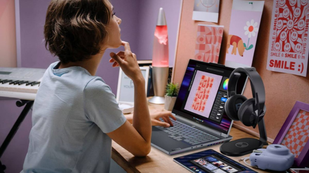 Student sitting at desk using a Lenovo laptop