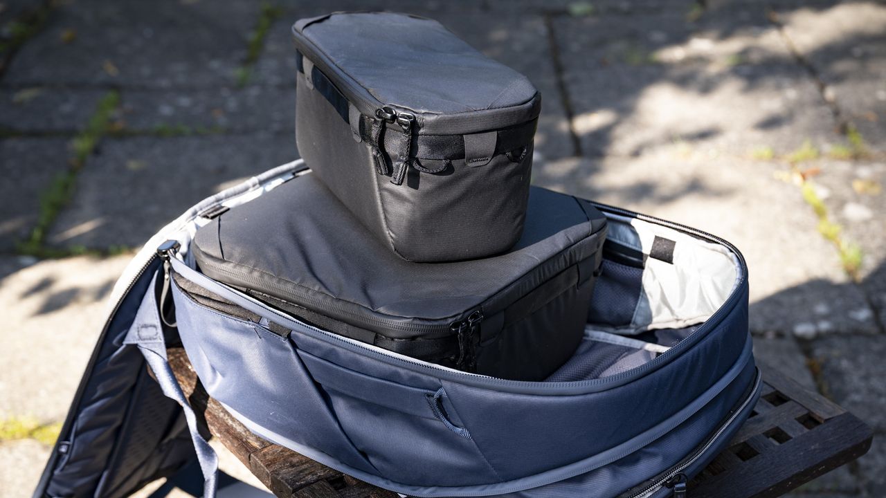 Peak Design Camera Cubes inside Traveller Backpack on wooden table outside