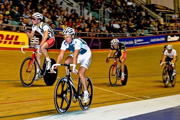 George Atkins wins the scratch race and salutes the packed crowd.