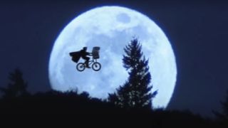 Elliott and ET flying past the moon on a bike