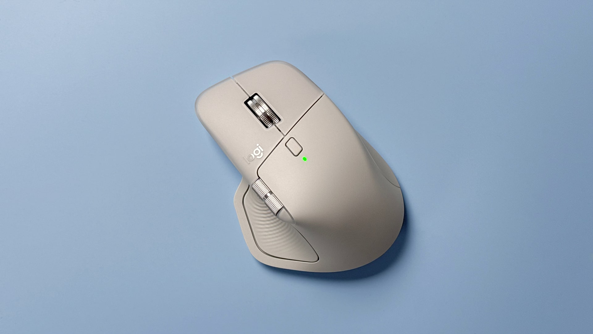 The Logitech MX Master 4 mouse against a blue background.