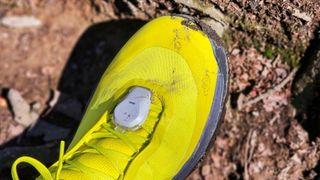 Coros Pod 2 attached to a person's shoe outside