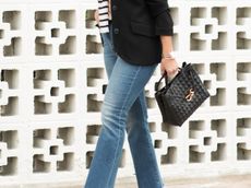 Susie Wright carries a Bottega Veneta Andiamo bag in black.