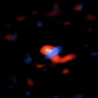 An image from ALMA shows cool hydrogen gas flowing around the Milky Way center's supermassive black hole, Sagittarius A*. The red portion of the gas is moving away from Earth and the blue portion is moving toward Earth. The crosshairs show the location of the black hole.