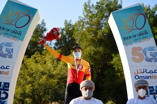 QURAYYAT OMAN FEBRUARY 12 Anthon Charmig of Denmark and UNO X Pro Cycling Team celebrates winning the stage on the podium ceremony after the 11th Tour Of Oman 2022 Stage 3 a 180km stage from Sultan Qaboos University to Qurayyat 240m TourofOman on February 12 2022 in Qurayyat Oman Photo by Dario BelingheriGetty Images