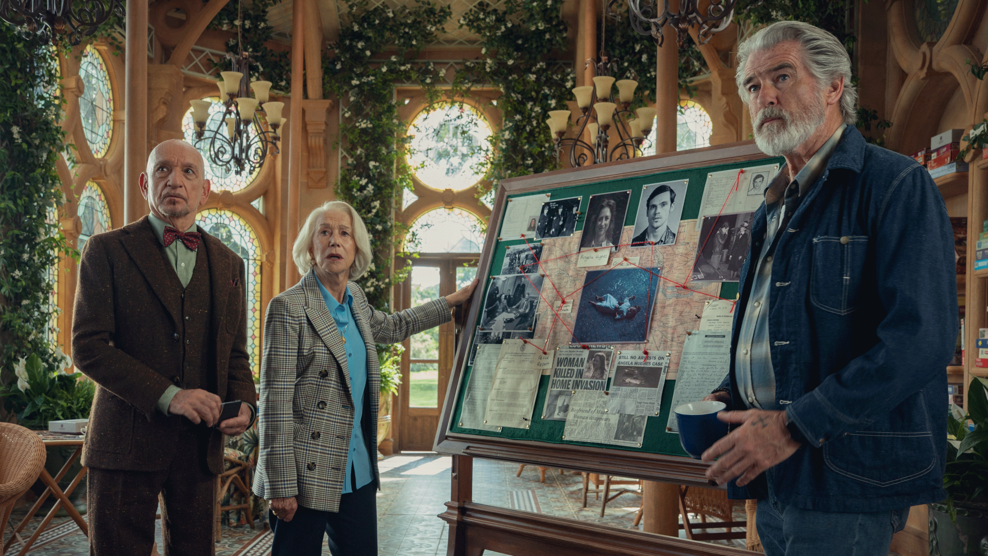 Thursday Murder Club cast on set in orangery with murder board