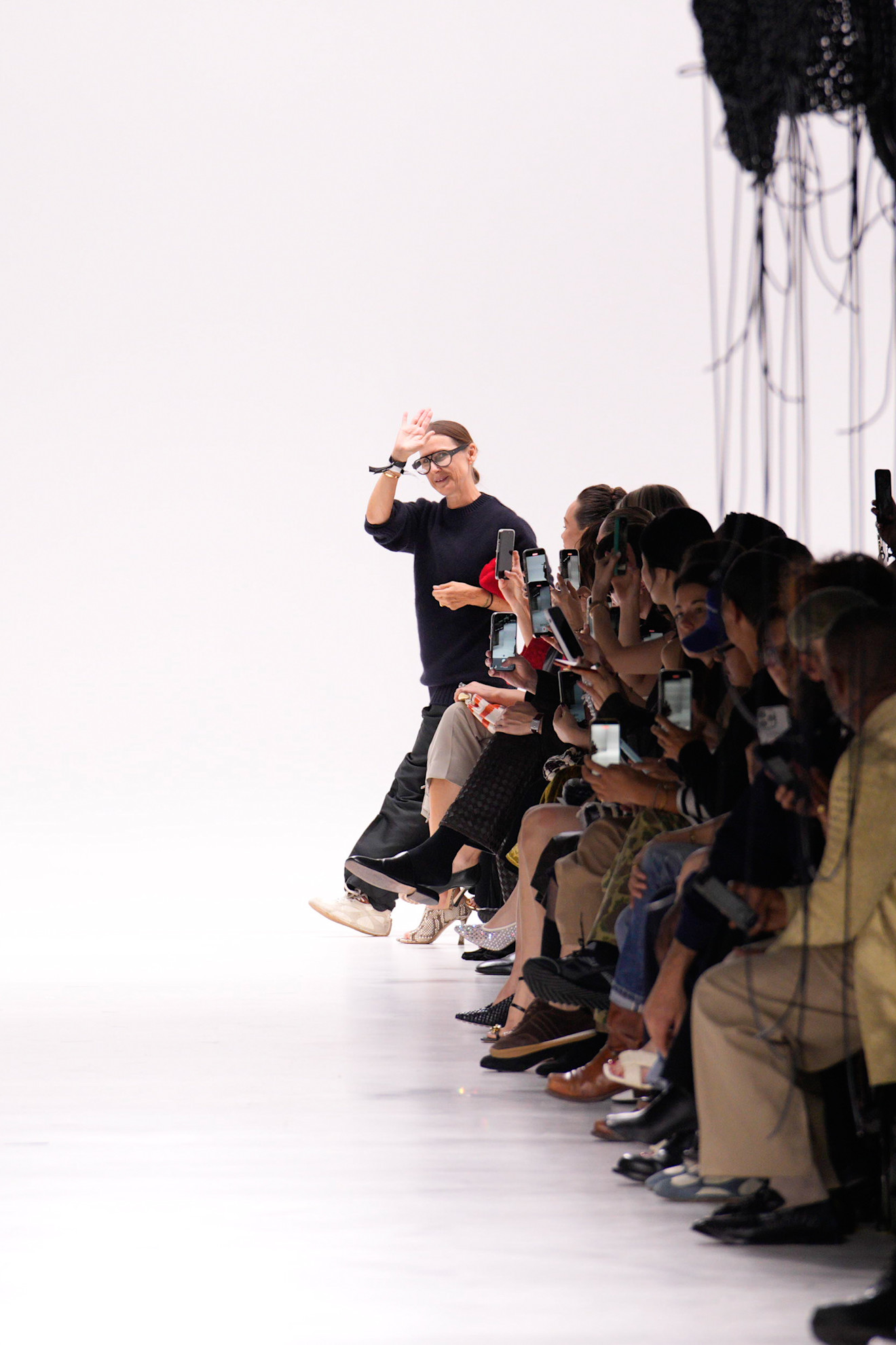 Louise Trotter waves during the finale of her first Bottega Veneta show as creative director.