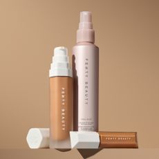 three fenty beauty products in front of a plain backdrop including the new fenty beauty setting spray