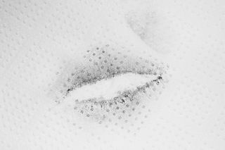 Print of lips on white napkin