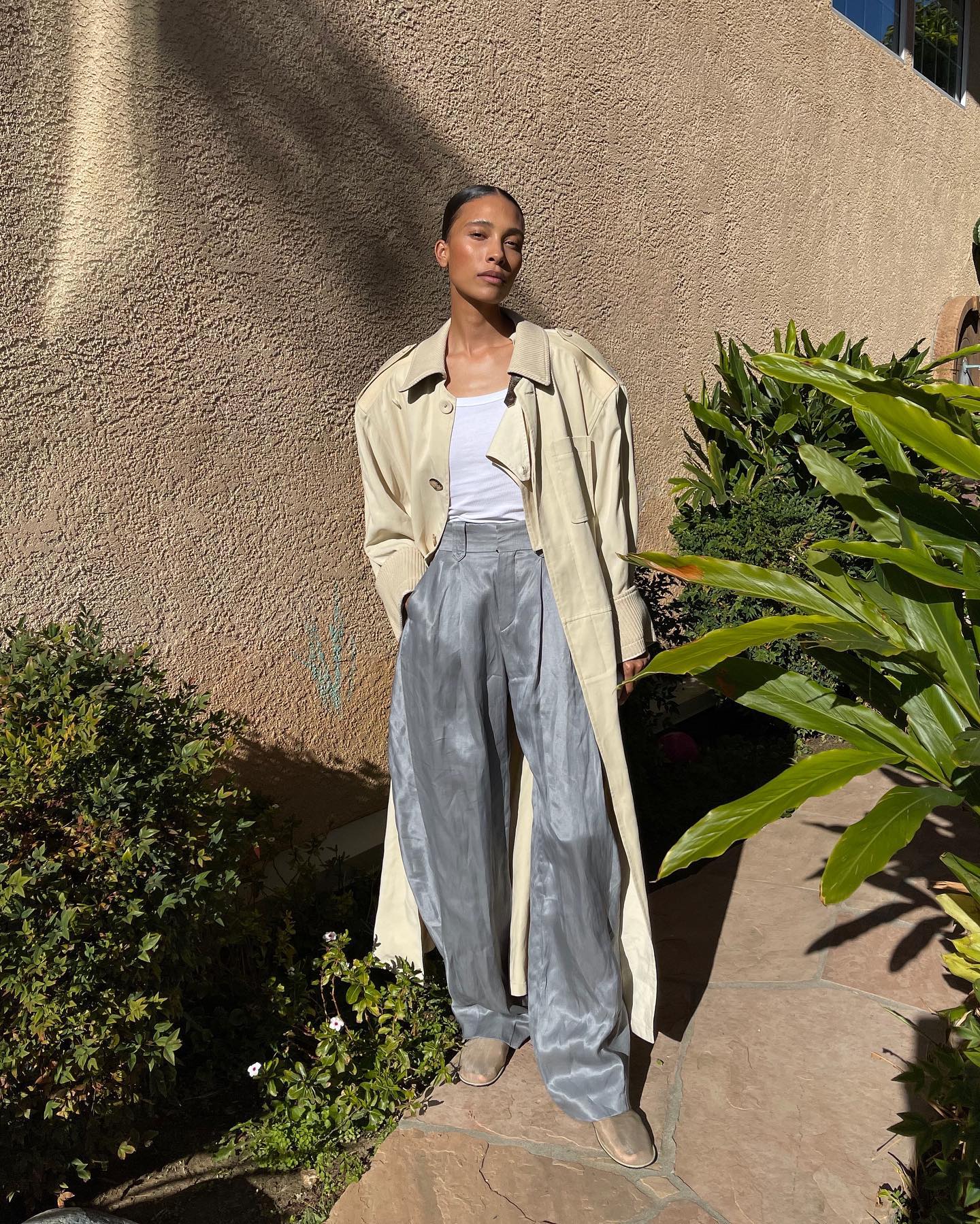 TyLynn Nguyen 31 Affordable Quiet Luxury Finds for Expensive-Looking Outfits Leather Trench Coat White Top Metallic Silver Pants The Row Mesh Shoes