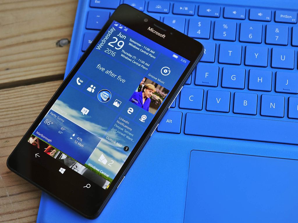 Windows 10 Mobile phone on a keyboard.