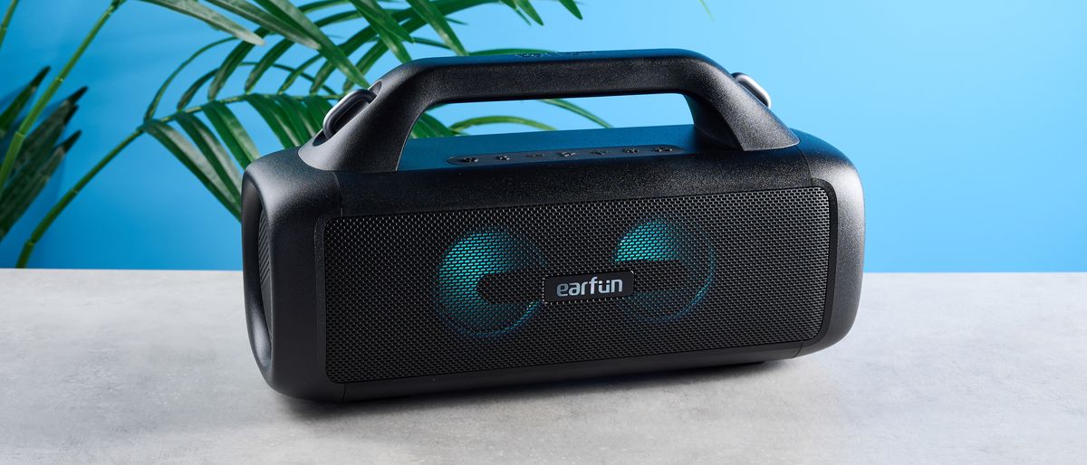 the EarFun UBOOM X portable boombox speaker with an LED light show and an earfun logo in the center of the speaker grille and two subwoofers and a carry strap, perfect for beach parties rated IP67