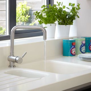 kitchen sink with tap and window behind