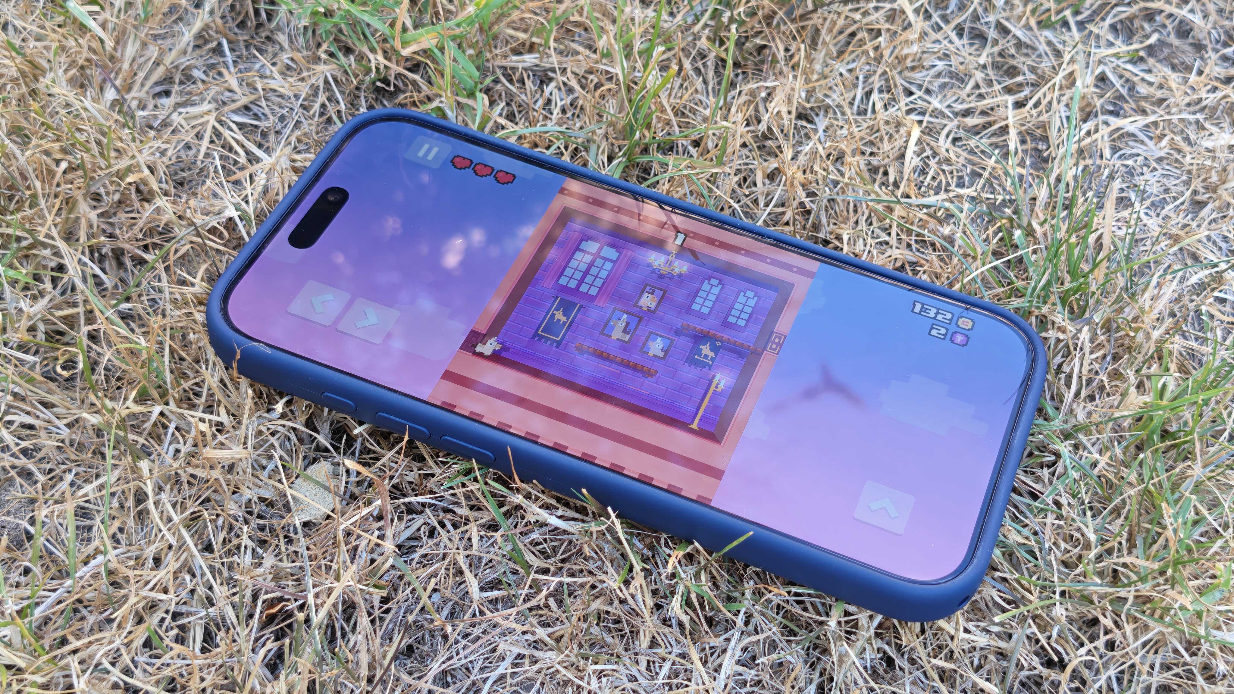 Apple Arcade being used on an iPhone 17 Pro Max in a grassy outdoor space.