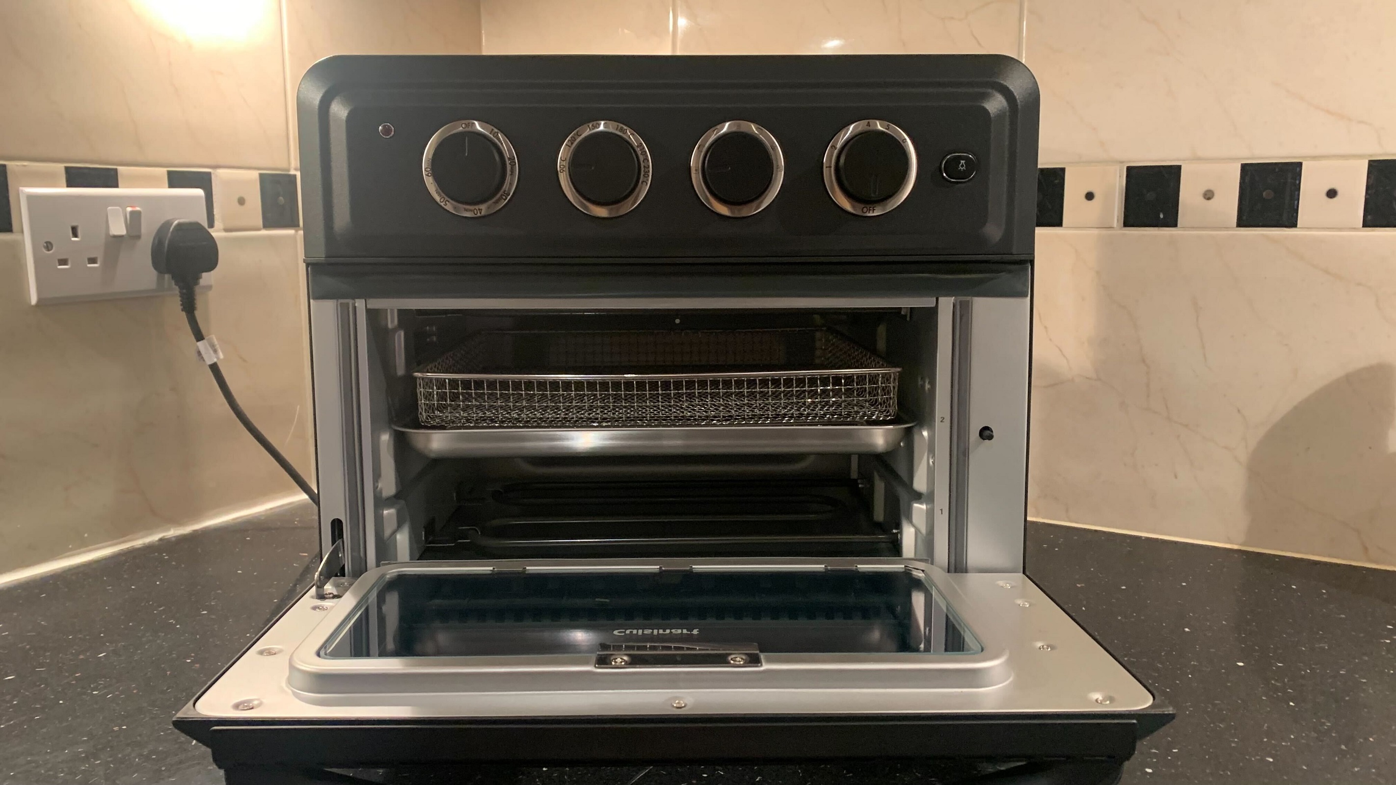 Cuisinart Air Fryer Mini Oven with door open to reveal accessories