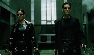 The Matrix Carrie-Anne Moss and Keanu Reeves make their way through the lobby, armed