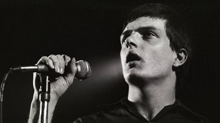 Ian Curtis performing live onstage at the Lantaren
