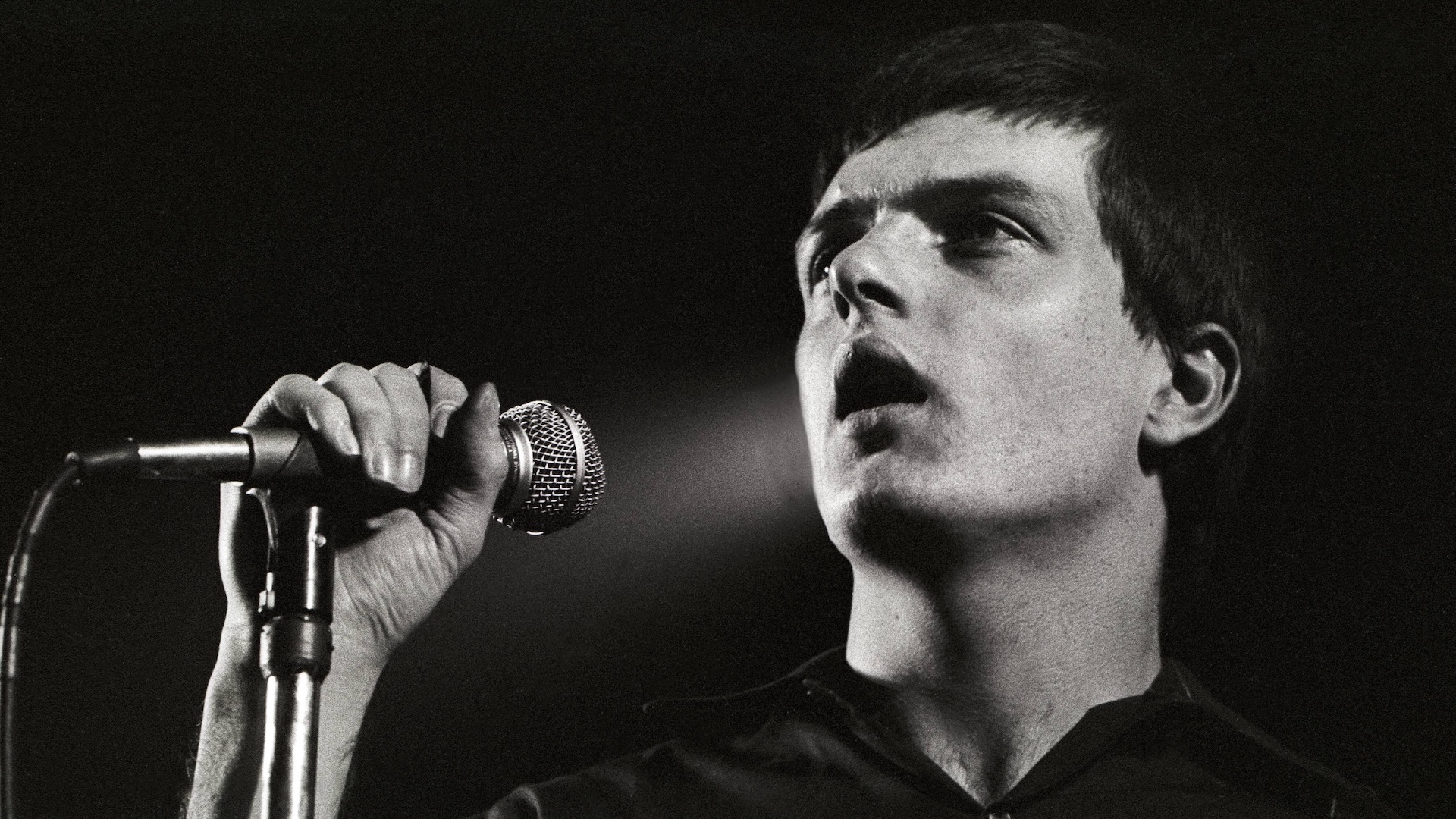 Ian Curtis performing live onstage at the Lantaren 