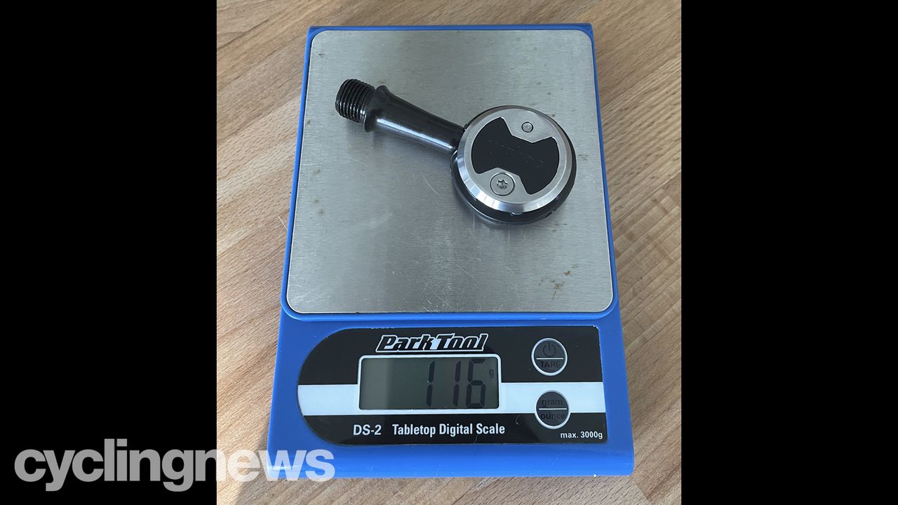 A Wahoo Speedplay Comp pedal on a Park Tool scale showing a weight of 116g