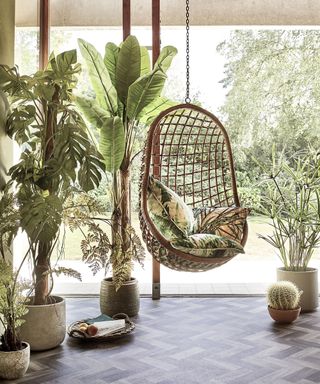 Rattan egg chair in conservatory by Carpetright