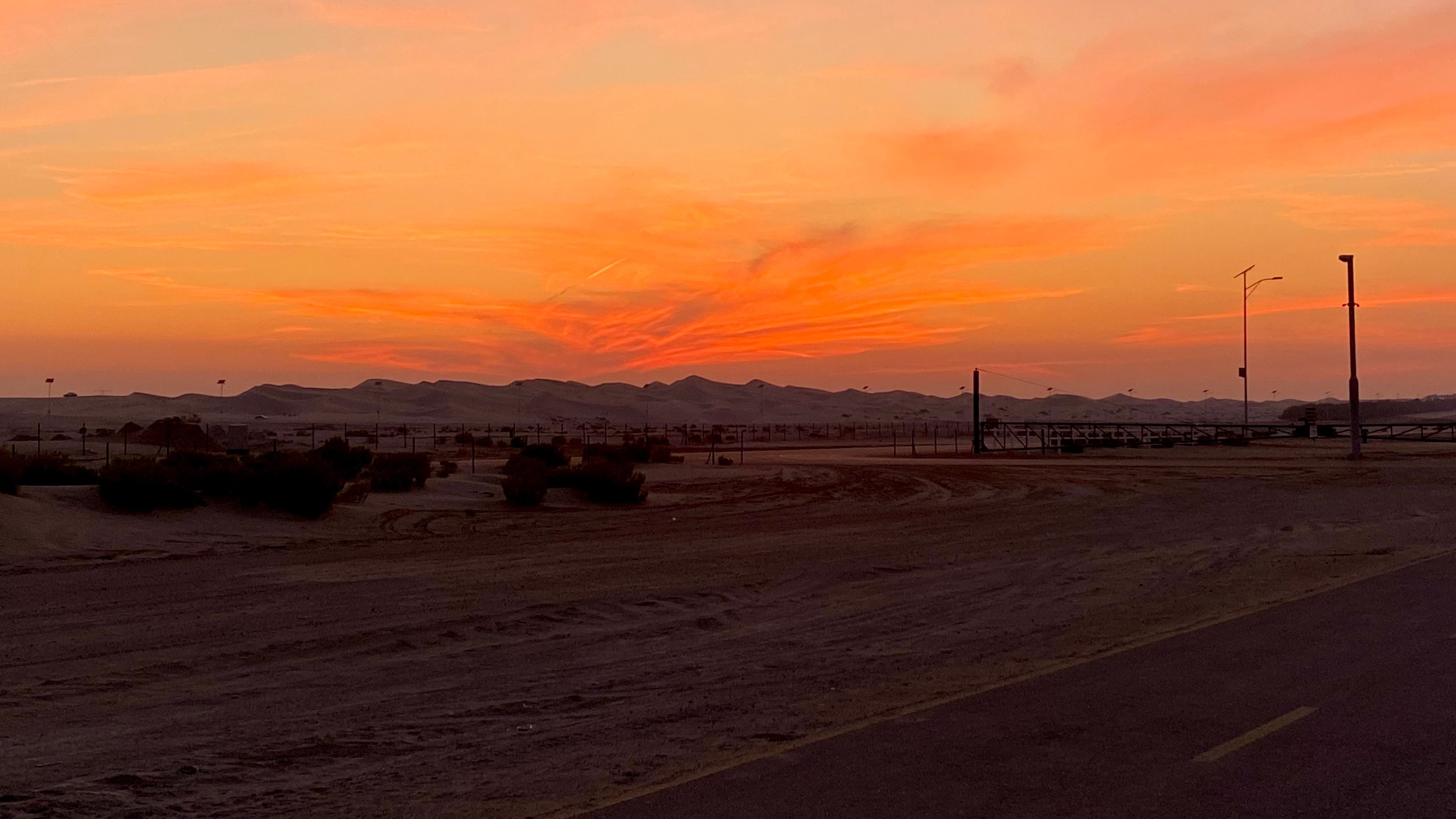 The sun setting over the Al Wathba desert