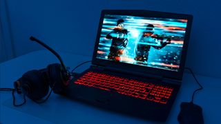 Stock photography of a gaming laptop, headset and mouse
