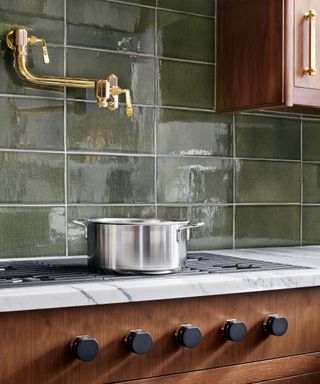 Green tiles and mixed metallic in pot filler trend
