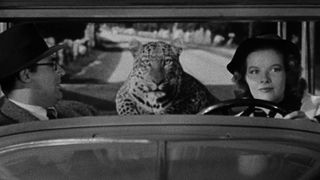 cary grant and katherine hepburn ride in a car with a leopard in Bringing Up Baby