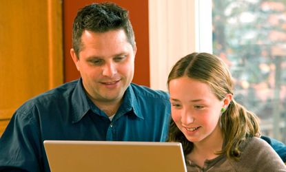 Father and daughter on computer