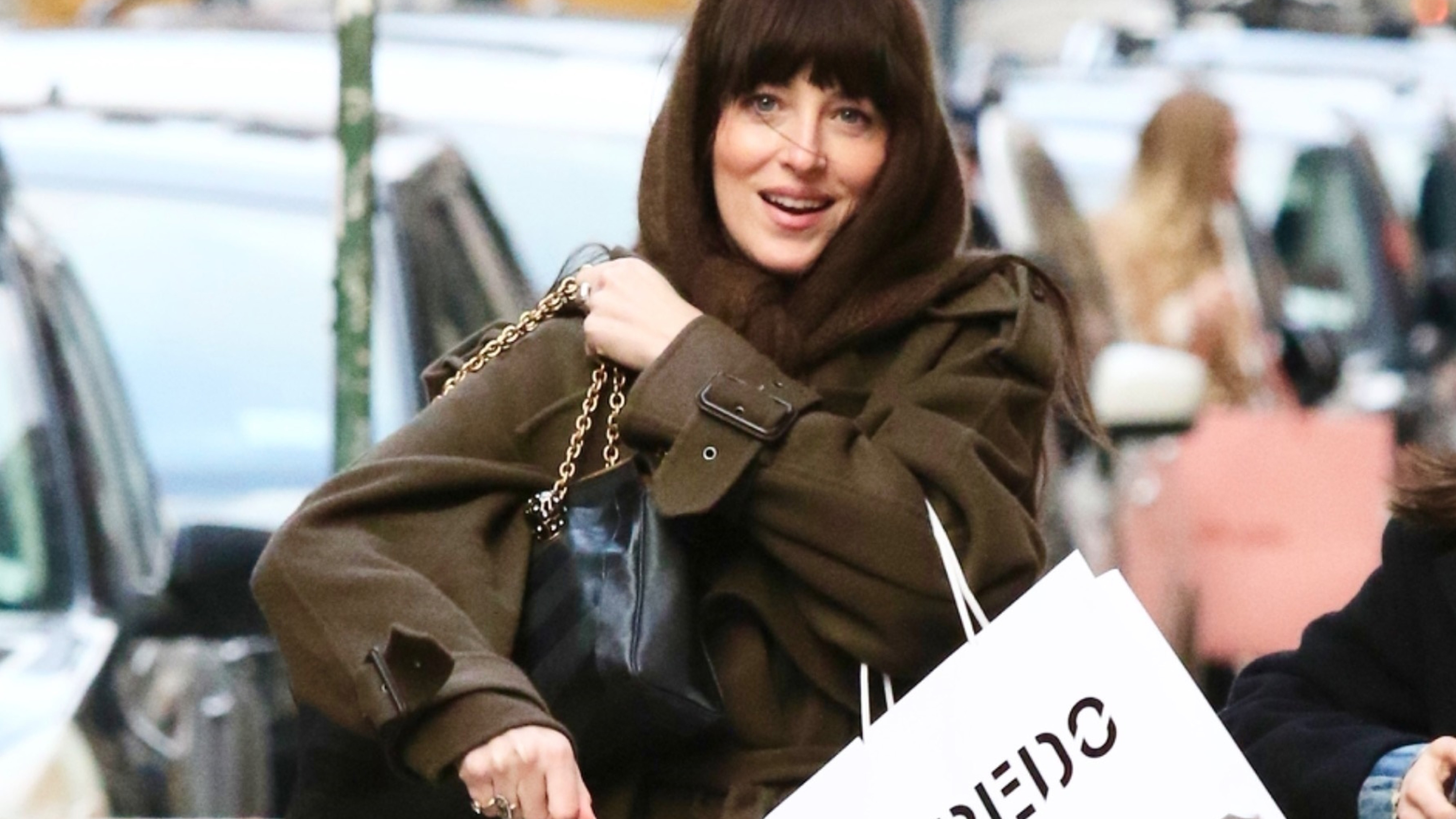 Dakota Johnson sports a stylish wardrobe with a headscarf while shopping in NYC