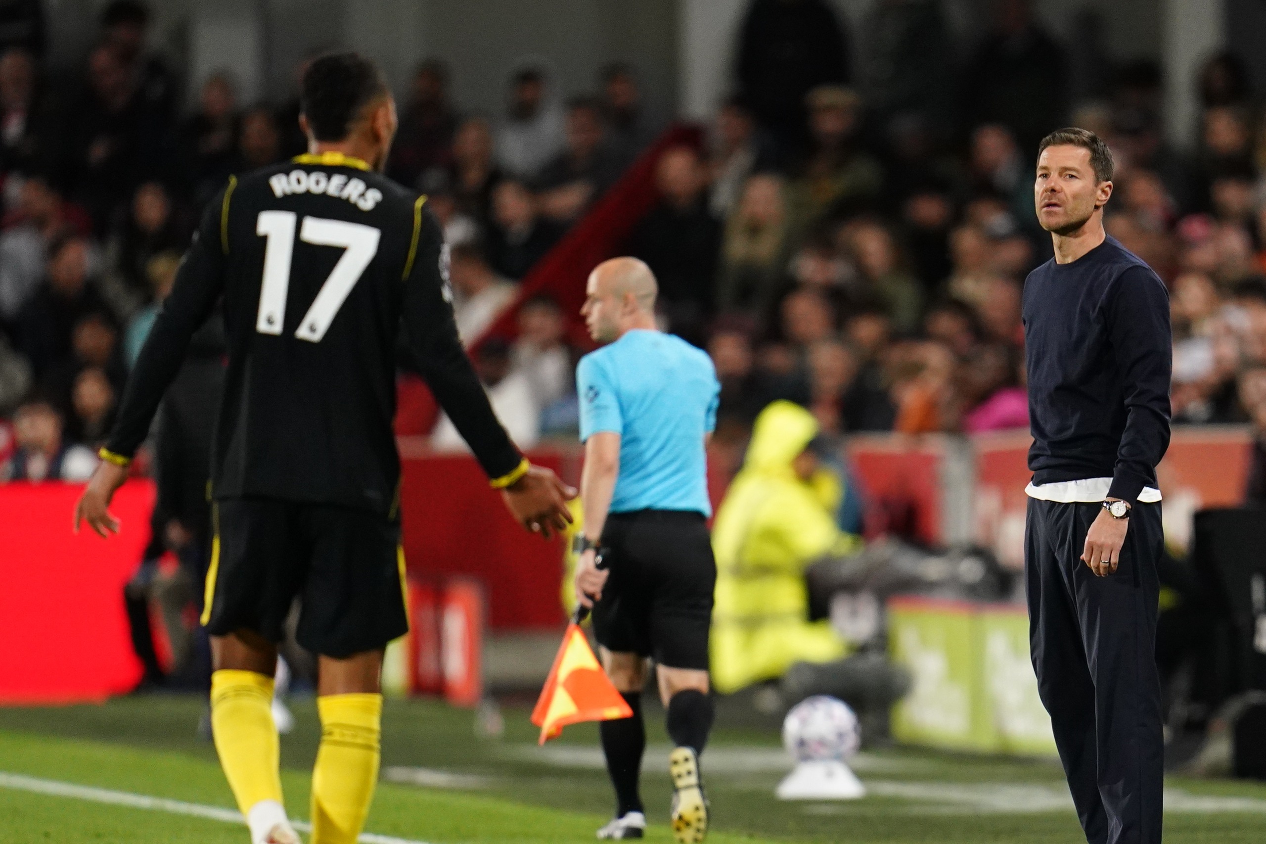 Morgan Rogers shouts in the direction of Xabi Alonso, manager of Chelsea, who watches the Premier League match between Brentford and Chelsea at Gtech Community Stadium