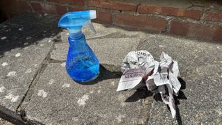 Using newspaper and vinegar to clean a window