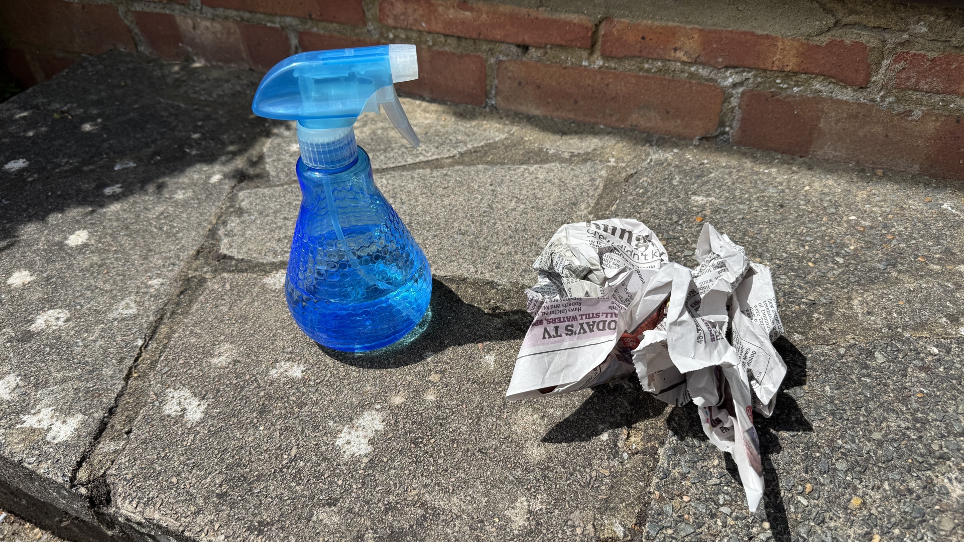 Using newspaper and vinegar to clean a window