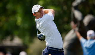 Rory McIlroy strikes a tee shot with a driver