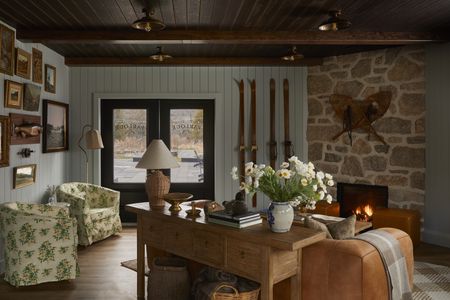 An entryway space with two flower patterned accent chairs