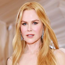 Nicole Kidman has long, golden blonde hair as she poses on the red carpet at the Met Gala 2023