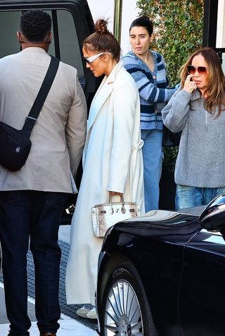 Jennifer Lopez in a white coat and rare Birkin bag while shopping in Los Angeles.