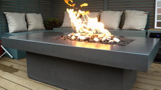 deck at night with firepit and seating