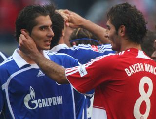 Schalke's Halil Altintop chats to brother Hamit Altintop ahead of a game against Bayern Munich in September 2007.