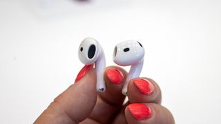 Apple AirPods 4 earpieces in the hand