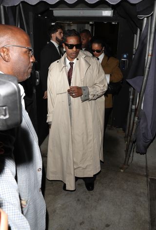 Asap rocky rings in rihanna's 37th birthday on Feb. 20 at The Nice Guy in West Hollywood wearing a trench coat and matching tie.