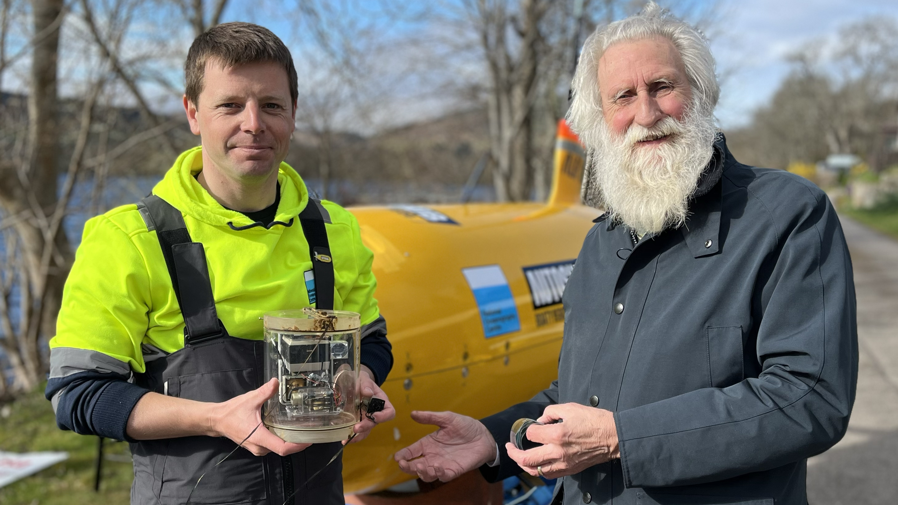 Researchers found a 1970 camera trap originally set up to research the Loch Ness legend. Here, two researchers hold the camera in front of the sub Boaty McBoatface
