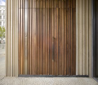 A wooden door with vertical line designs in shades of brown