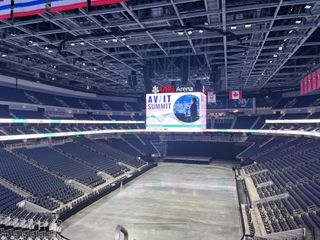 The UBS Arena displaying the AV/IT signage on the centerhang and ribbon displays.