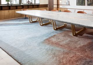Moët Hennessy office boardroom with marble table and large rug by Barbarito Bancel Architectes