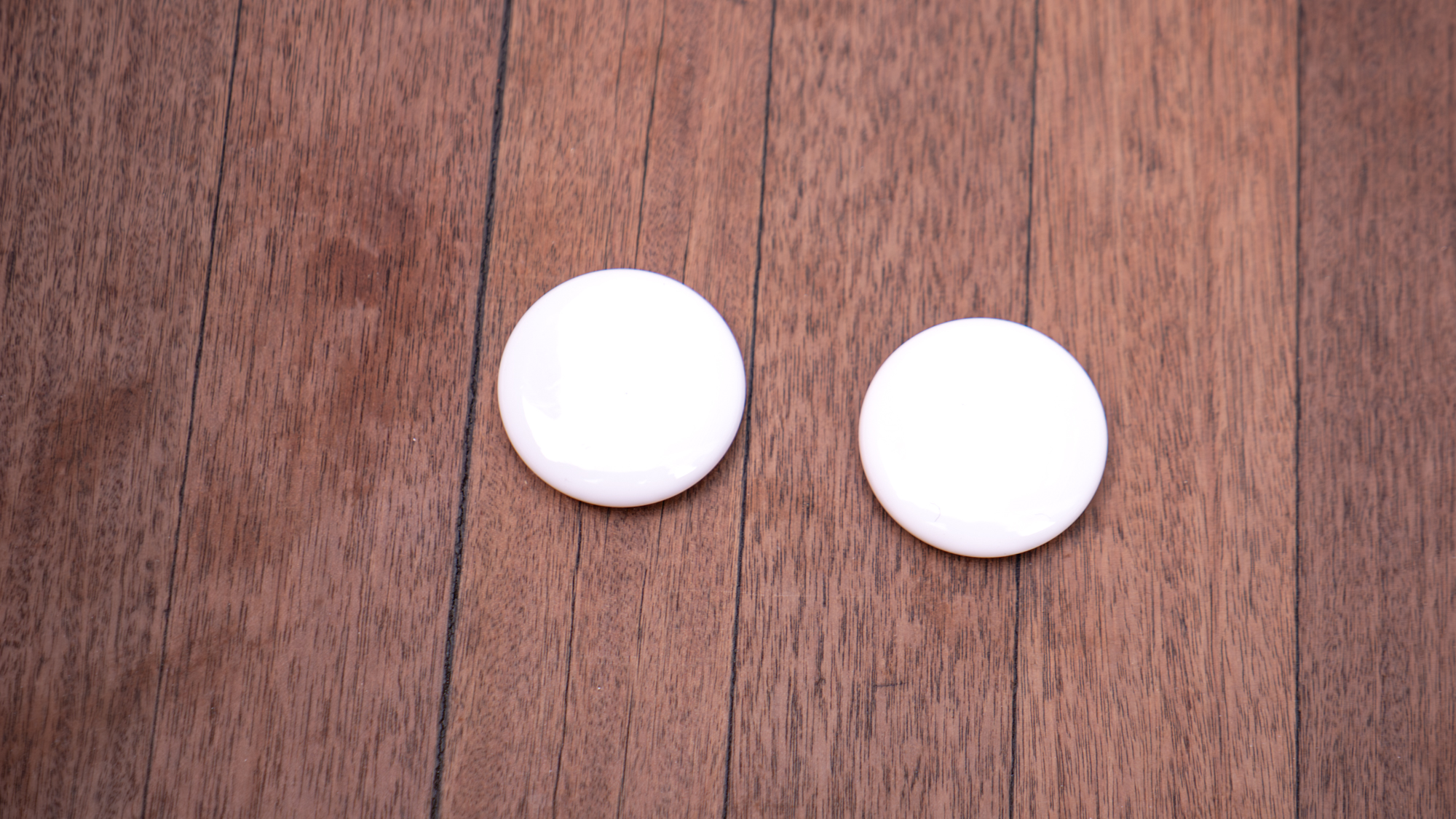 Apple AirTag 2 held in the hand.