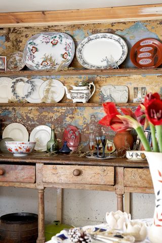 styling shelves: antique distressed shelving with ornamental plates