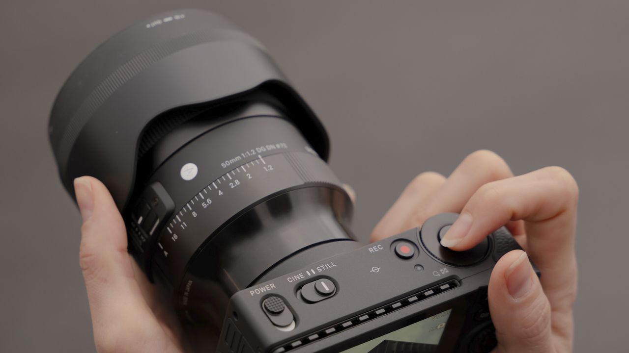 Sigma 50mm F1.2 DG DN Art lens in the hand